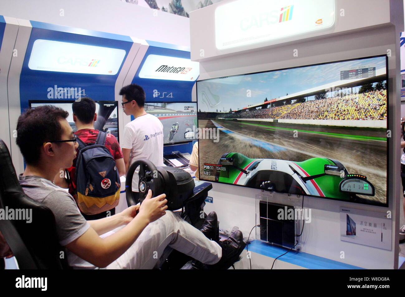 Visitors try out electronic racing games on Sony's PlayStation 4 or PS4 game  consoles during the 13th China Digital Entertainment Expo, also known as  Stock Photo - Alamy