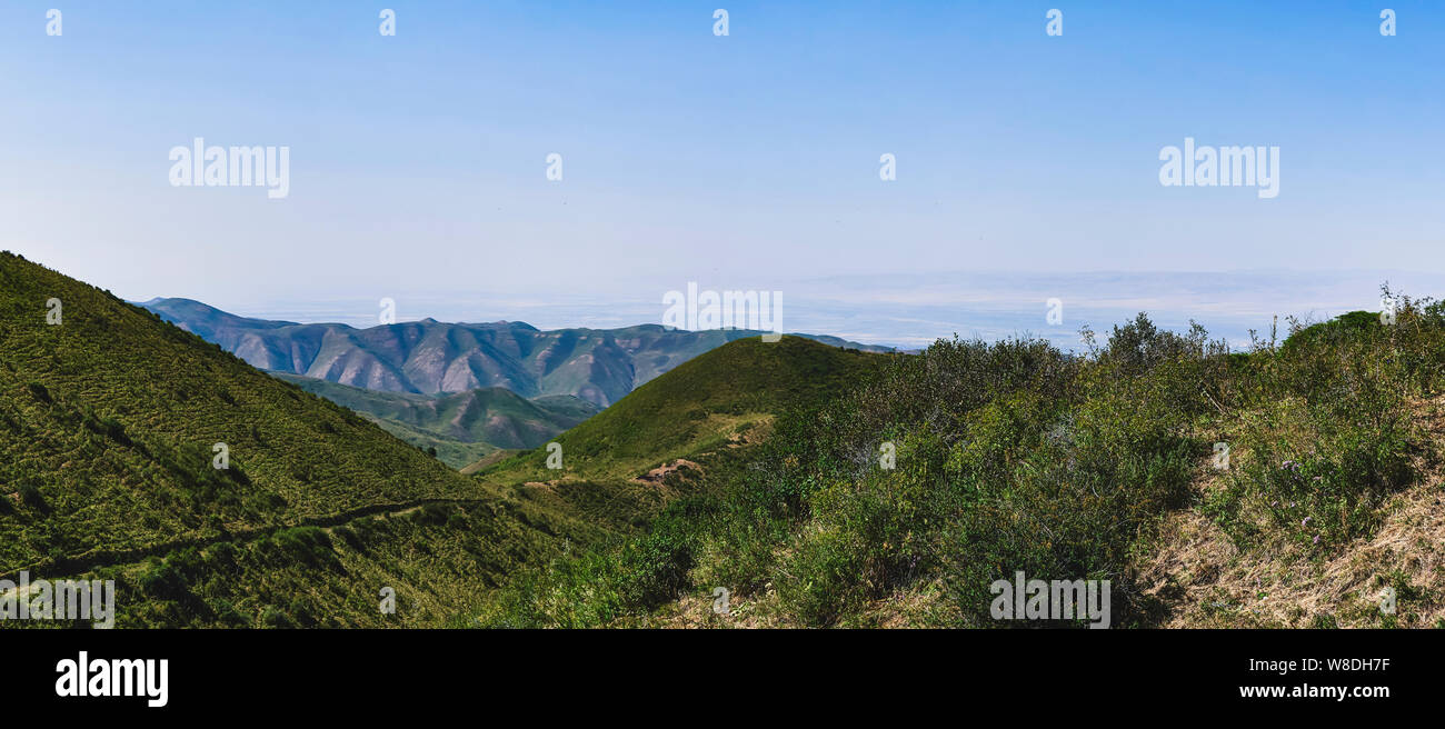 Panorama of a mountain valley in summer, aerial view. A fabulous view of the mountain peaks, amazing nature, summer in the mountains. Travel, tourism. Stock Photo
