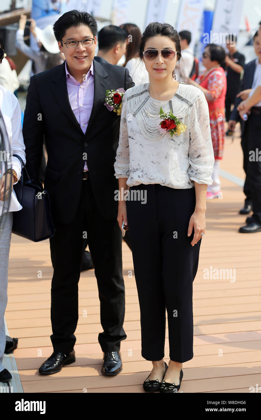 Kenneth Fok Kai-kong, eldest son of Hong Kong tycoon Timothy Fok Tsun-Ting, left, and his wife, Chinese Olympic diving champion Guo Jingjing, pose dur Stock Photo