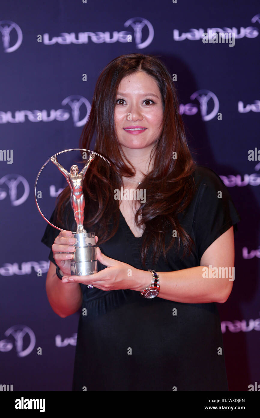 --FILE--Retired Chinese tennis star Li Na poses with her trophy after the award ceremony for the Laureus World Sports Awards Shanghai 2015 in Shanghai Stock Photo