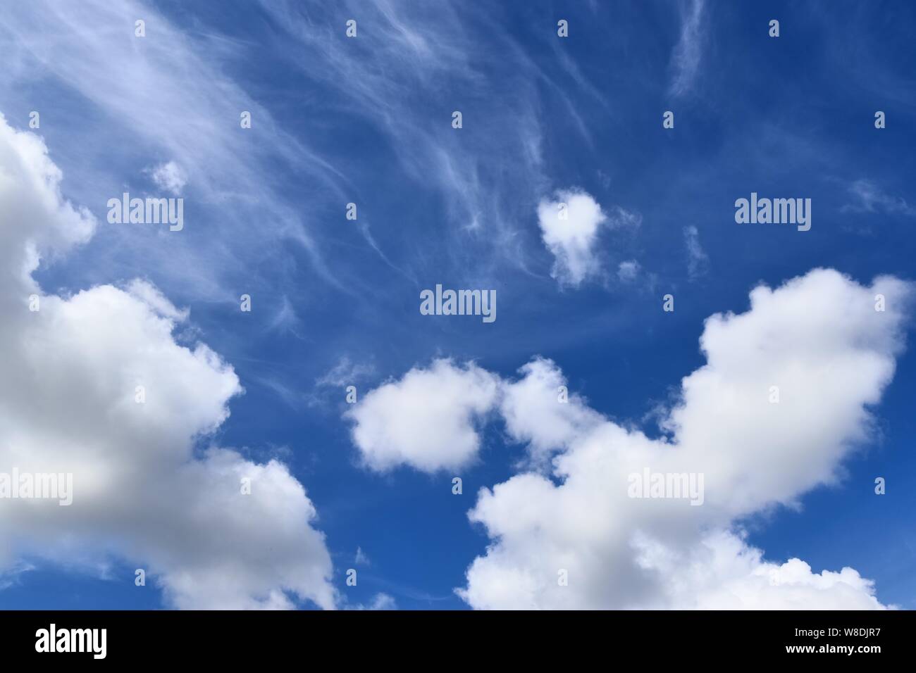 Beaufitul fluffy white clouds on a deep blue summer sky Stock Photo - Alamy