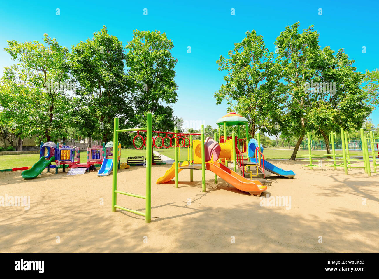 Local Playground Colorful children playground activities in public park surrounded by ...