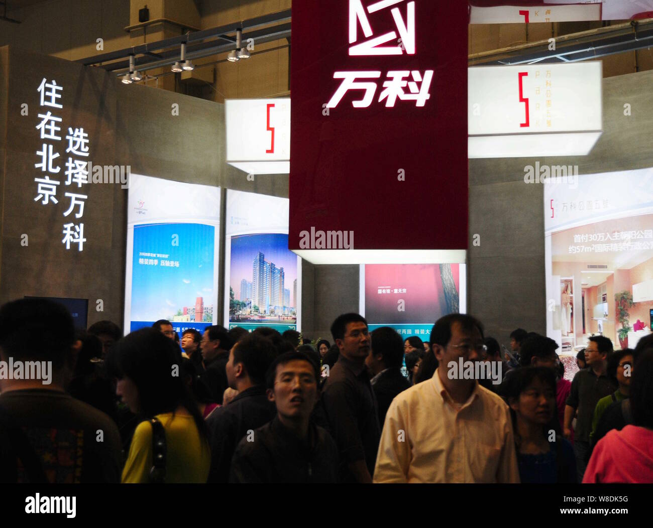 FILEVisitor crowd the stand of Vanke during a real estate fair in