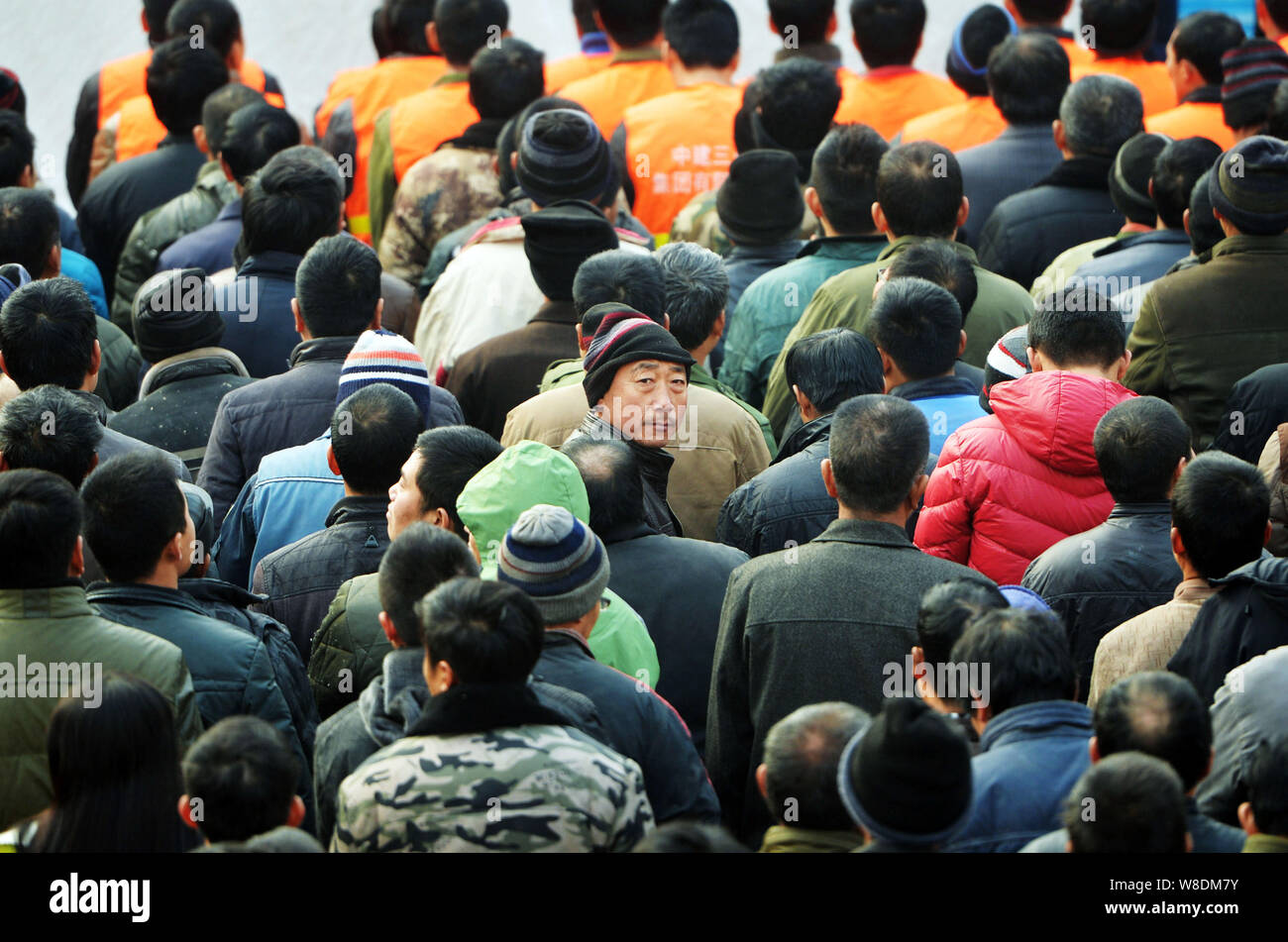 --FILE--Chinese migrant workers wait for free physical examinations at the construction site of a commercial property project in Shijiazhuang city, no Stock Photo