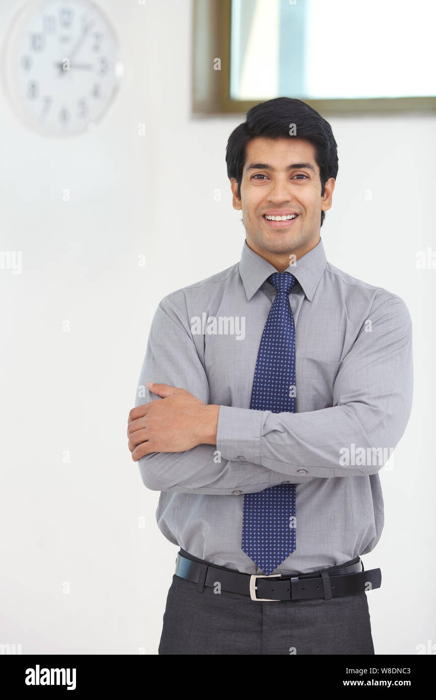 Businessman smiling with his arms crossed Stock Photo - Alamy