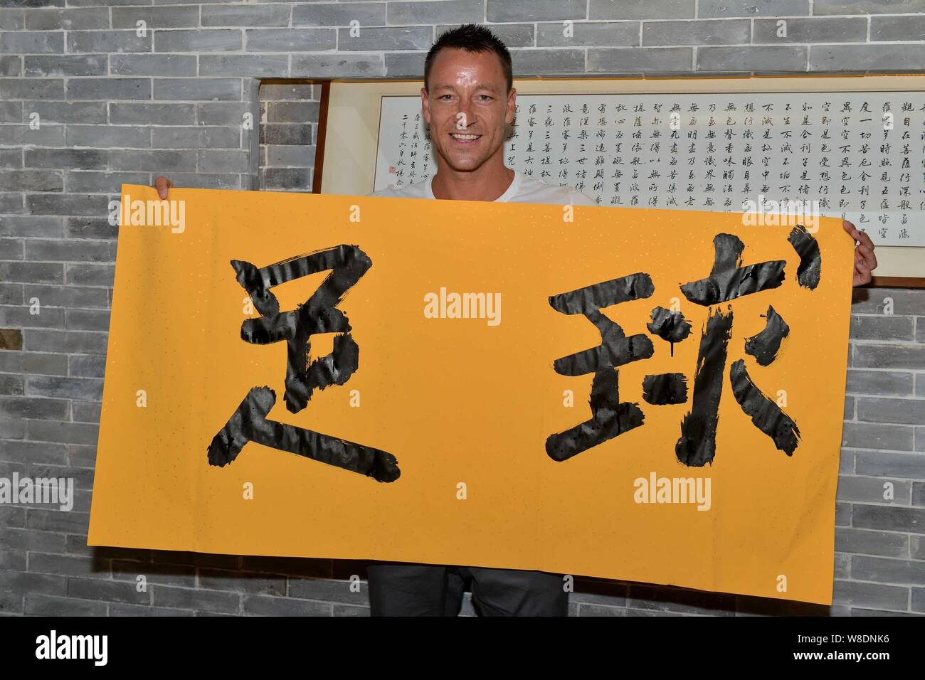 English soccer player John Terry shows his calligraphy of "Zuqiu