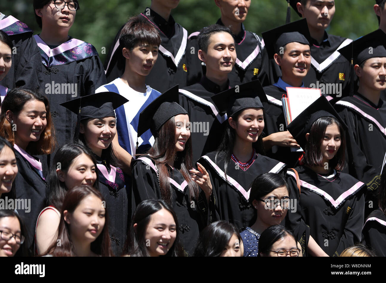 Chinese graduates pose for photos during a graduation ceremony at ...