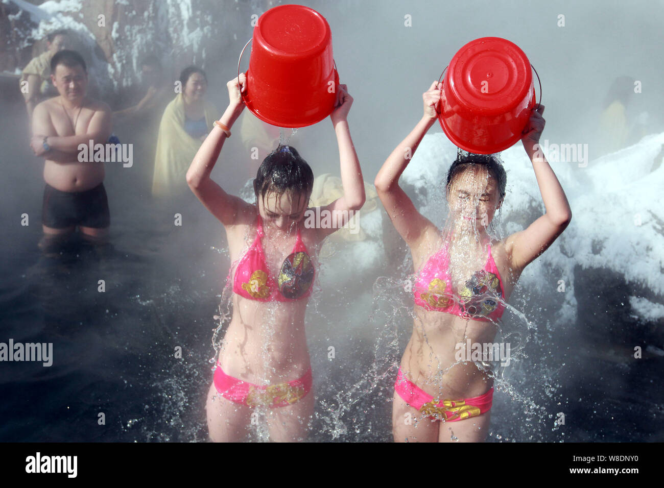 Two girls in bikini brave an ice bucket challenge in hot spring during a  charity event in Jilin city, northeast Chinas Jilin province, 28 January  2015 Stock Photo - Alamy
