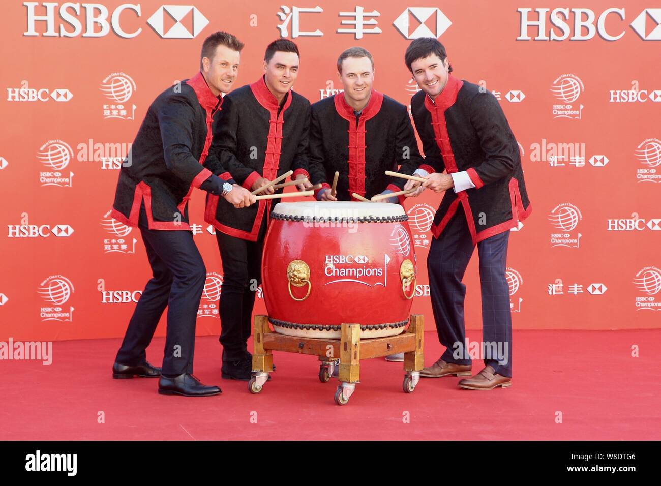 (From left) Henrik Stenson of Sweden, Rickie Fowler, Jordan Spieth and Bubba Watson of the United States beat a drum at the opening ceremony of the 20 Stock Photo