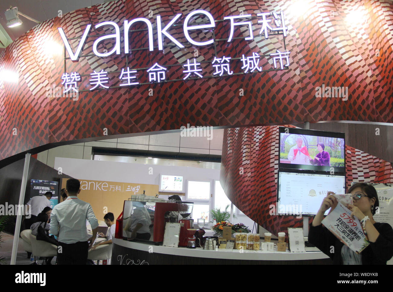 FILEPeople visit the stand of Vanke during a real estate fair in