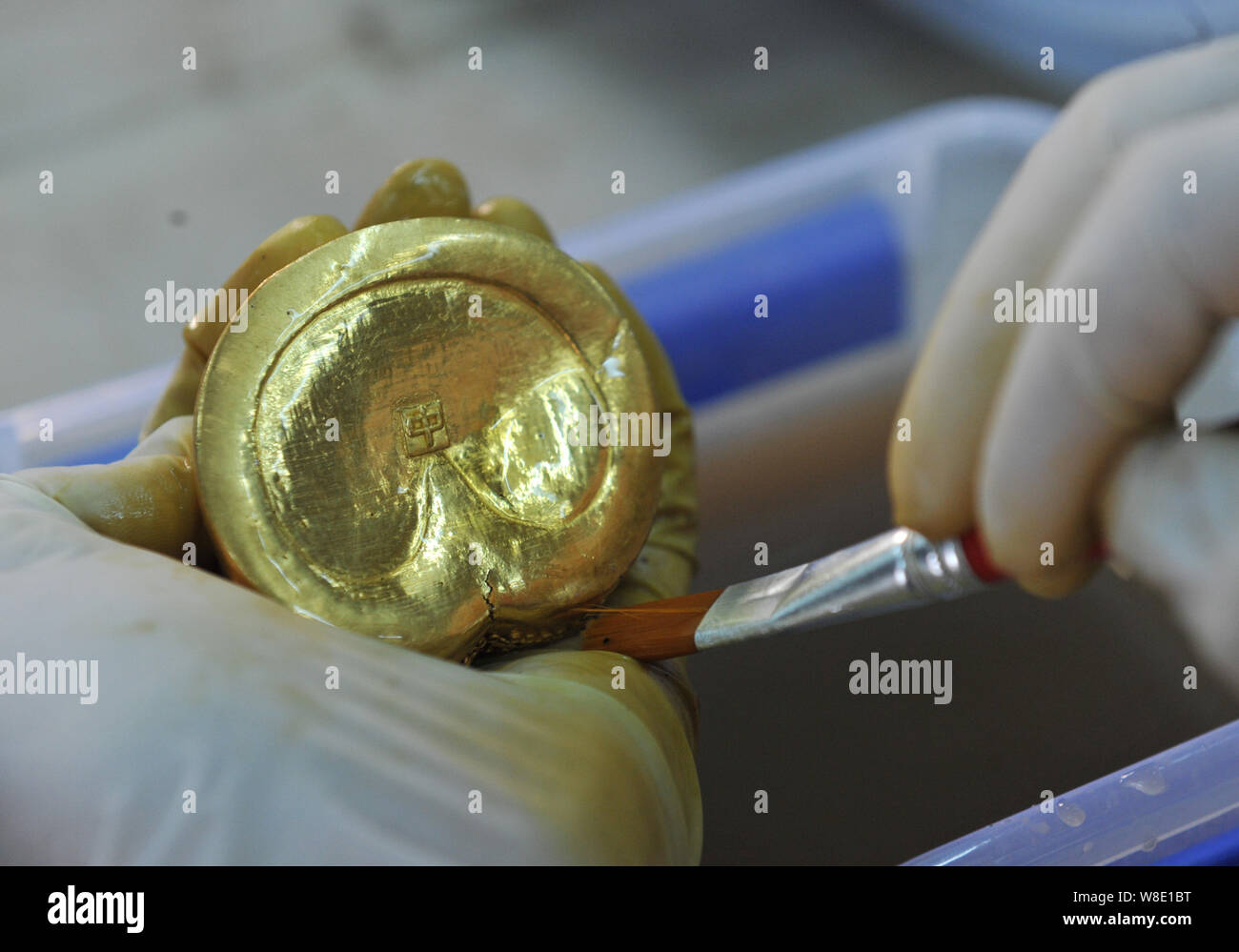 A Chinese Archaeologist Cleans A Hoof Shaped Gold Ingot With A Chinese Character Zhong Meaning Middle In English From The Tomb Of Haihunhou M Stock Photo Alamy