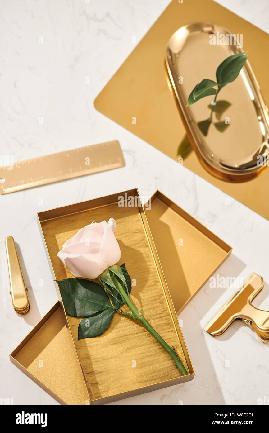 Gold items. Flat lay. Accessories on the table, woman desk top. View top table, background mock up. Envelope top Stock Photo