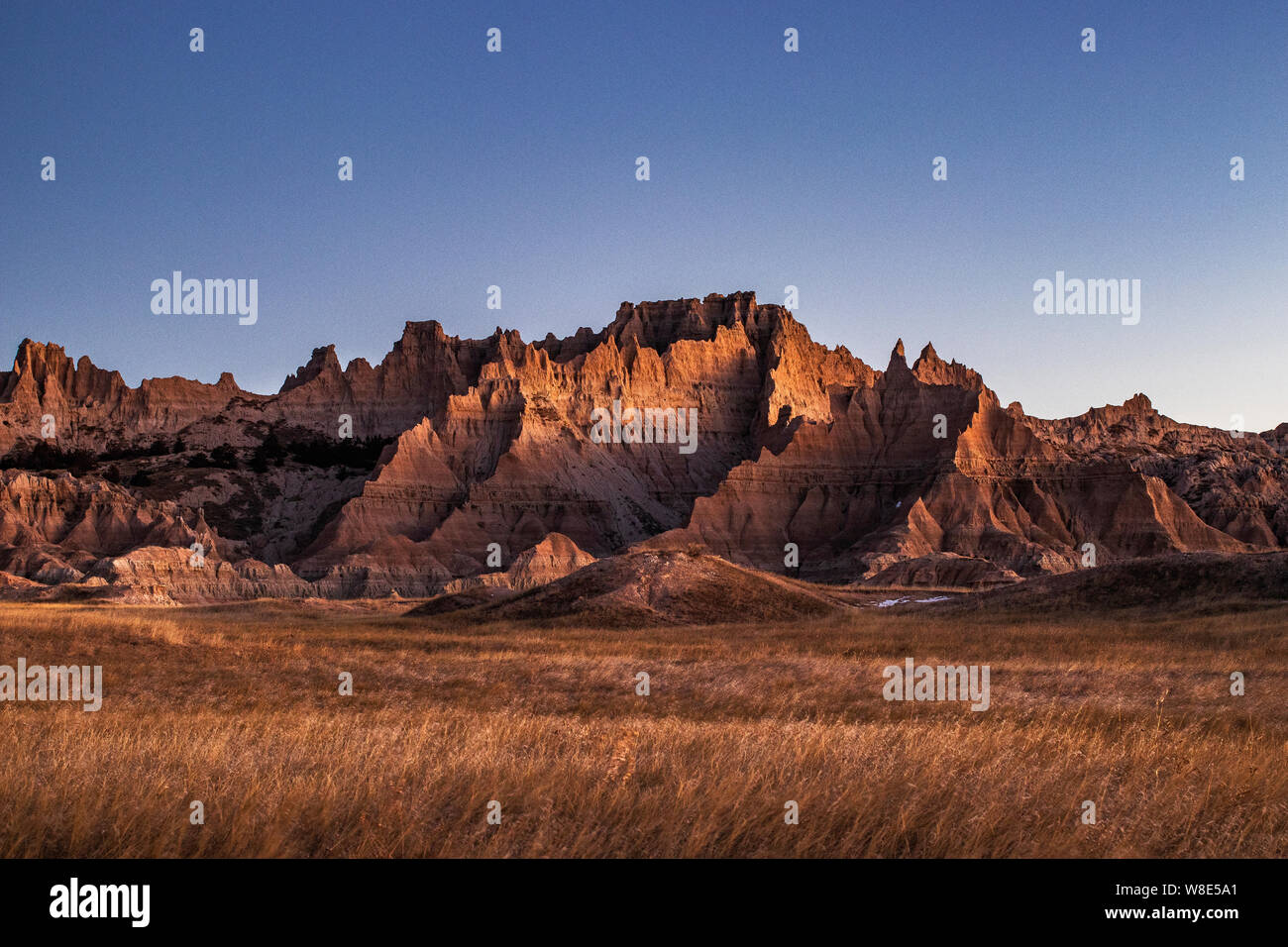 Badlands National Park is in South Dakota. Its dramatic landscapes span layered rock formations, steep canyons and towering spires. Stock Photo