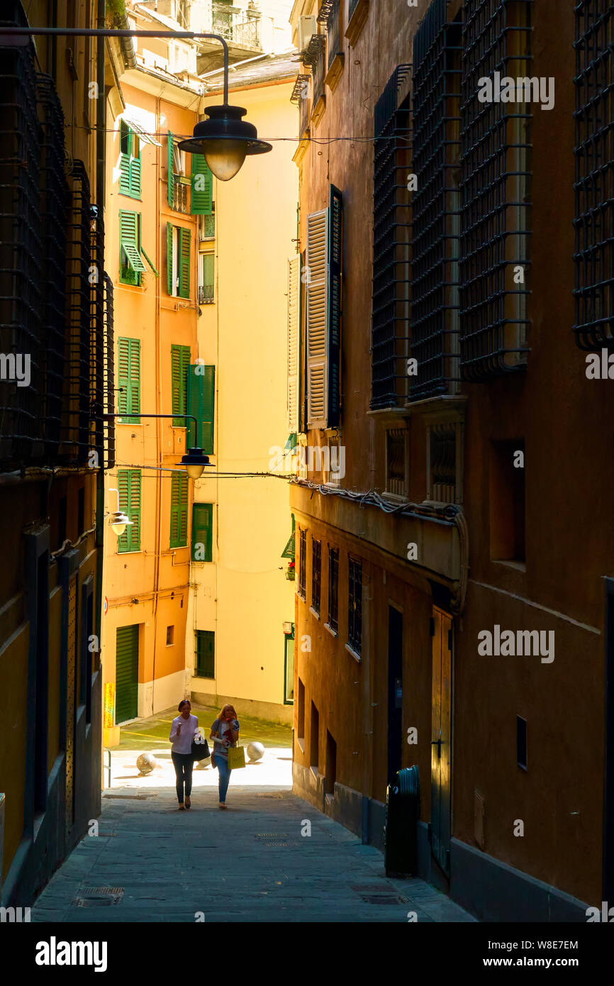 Genoa, Liguria, Italy - July 06, 2019:  Old street in Genoa and walking girls Stock Photo