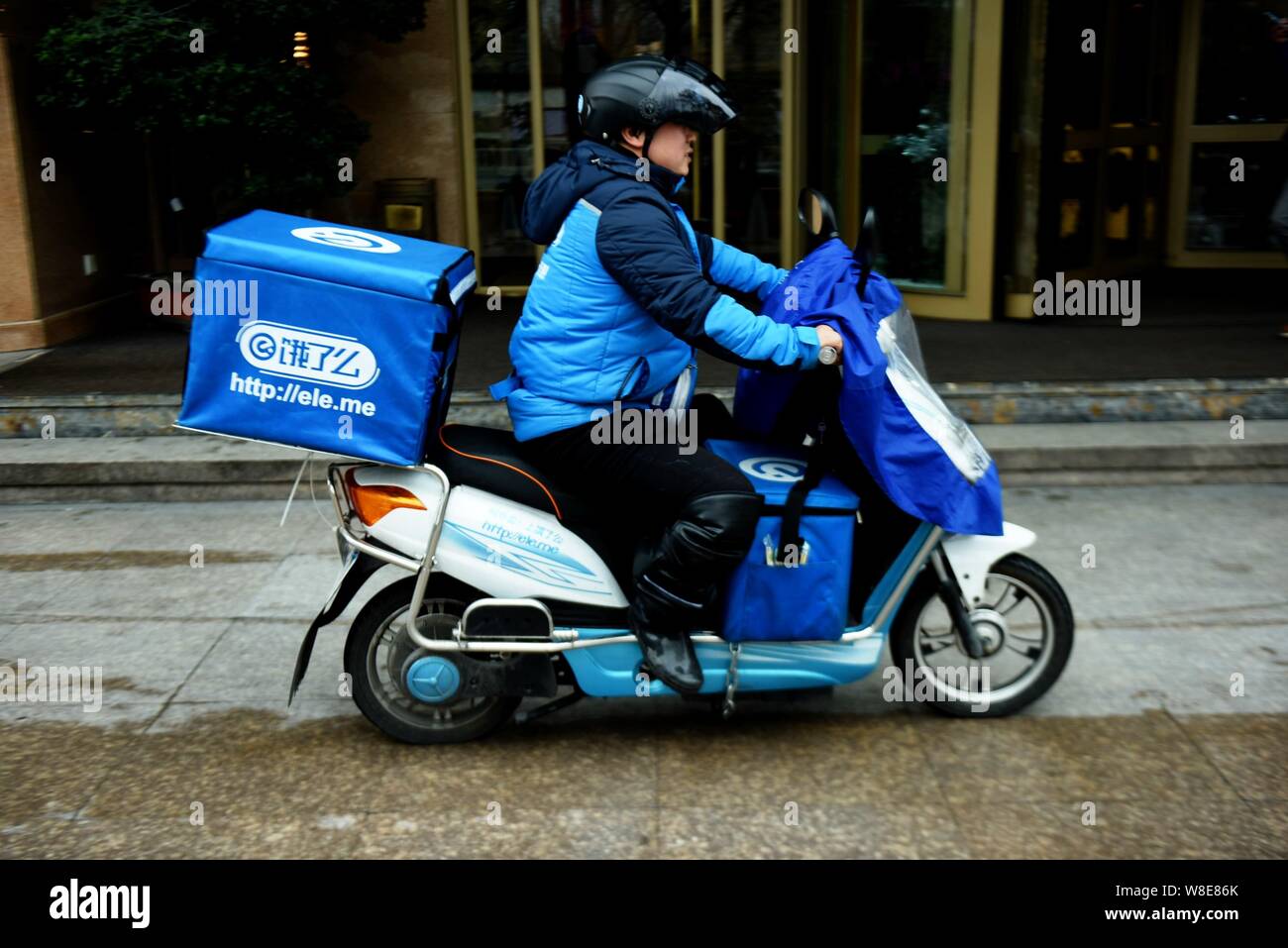 FILE A deliveryman of Chinese food delivery company Ele.me rides an electric bike to deliver meals in Shanghai China 24 March 2015. As China s e Stock Photo Alamy