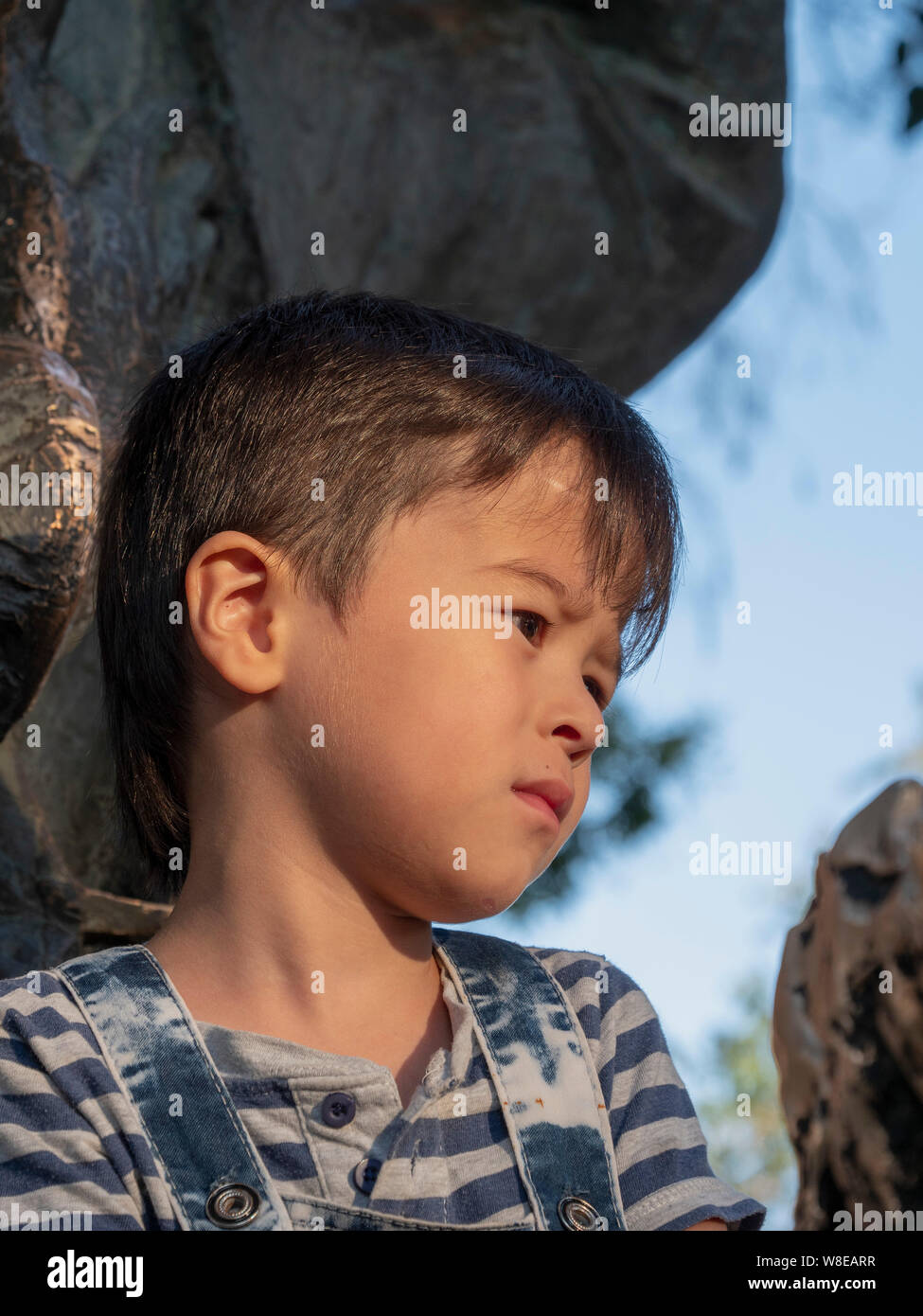 Boy at statue of Nasreddin, Historic City of Bukhara, Uzbekistan, Asia Stock Photo