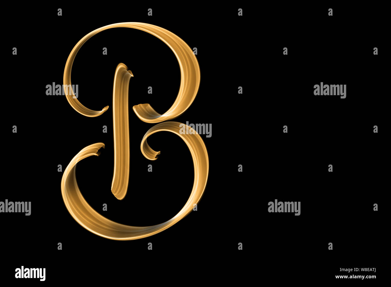 Golden capital letter B isolated on black with copy space - hand lettering Stock Photo