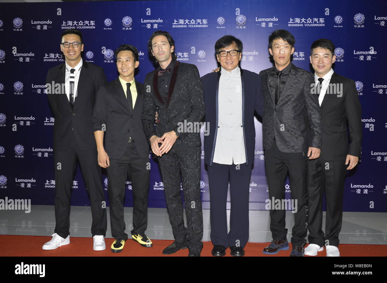 American actor Adrien Brody, third left, Hong Kong kungfu star Jackie Chan, third right, and other guests pose on the red carpet for the 16th Huading Stock Photo