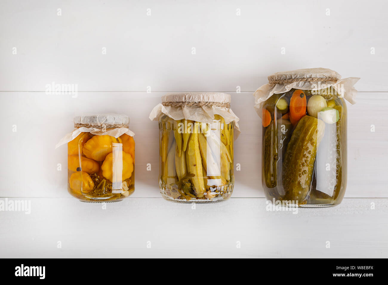Salting various vegetables in glass jars for longterm storage. Preserves vegetables in glass