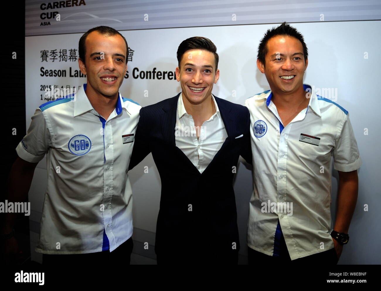 German gymnast Marcel Nguyen, center, poses during a press conference for the 2015 Porsche Carrera Cup Asia season in Hong Kong, China, 1 April 2015. Stock Photo