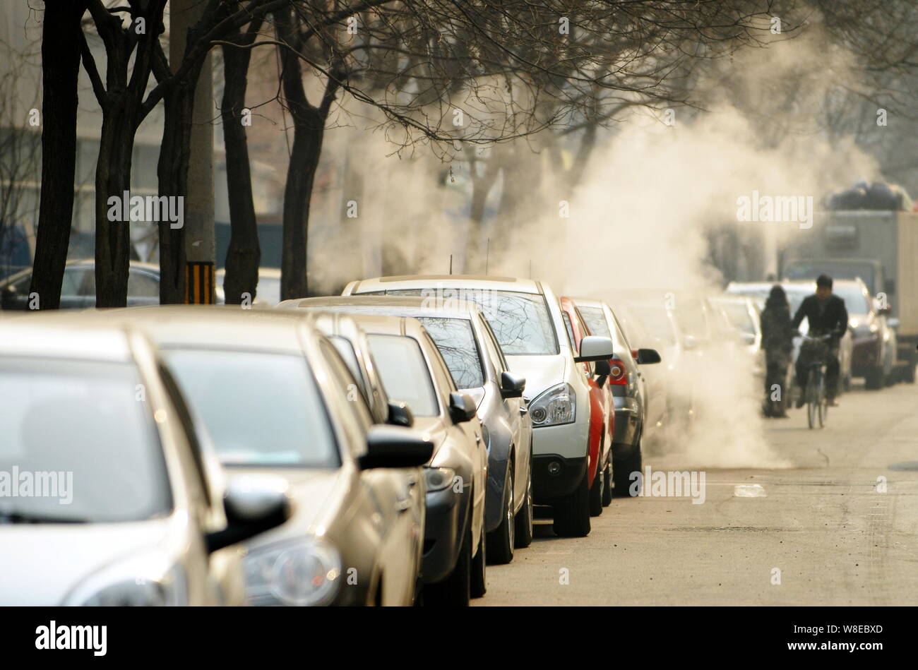 --FILE--Cars are parked along a street in Beijing, China, 13 February 2012.   Beijing plans to require local car buyers to show proof they have secure Stock Photo