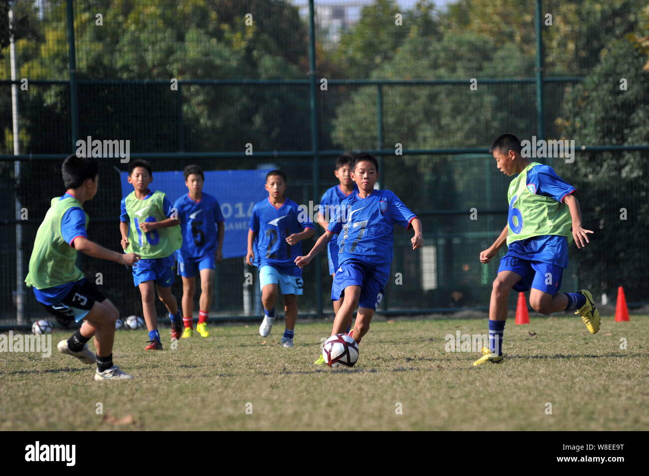 --FILE--Young Chinese boys compete during a training session at Jiangsu Guoxin Parma International Football School in Nanjing city, east China's Jiang Stock Photo