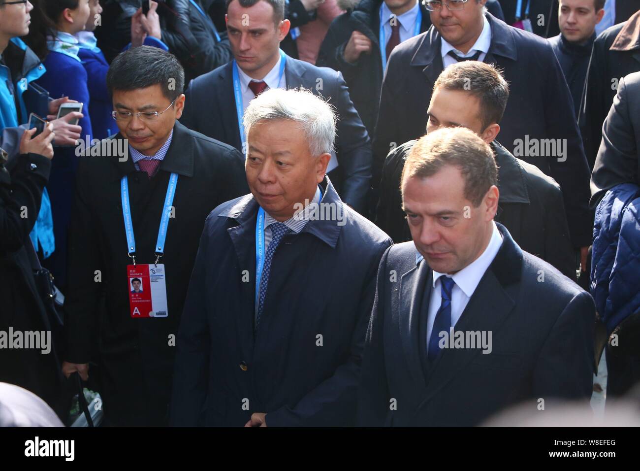 Russian Prime Minister Dmitry Medvedev, right, and Jin Liqun, center, President-elect of the Asian Infrastructure Investment Bank, leave after attendi Stock Photo