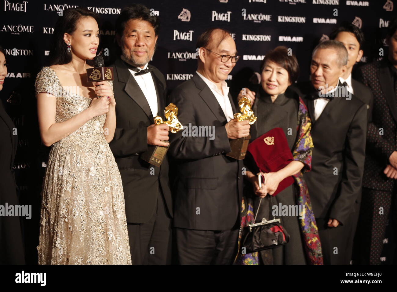 Taiwanese actress Shu Qi, left, cinematographer Mark Lee Ping Bing, second left, and director Hou Hsiao-hsien, right, pose during the 52nd Golden Hors Stock Photo