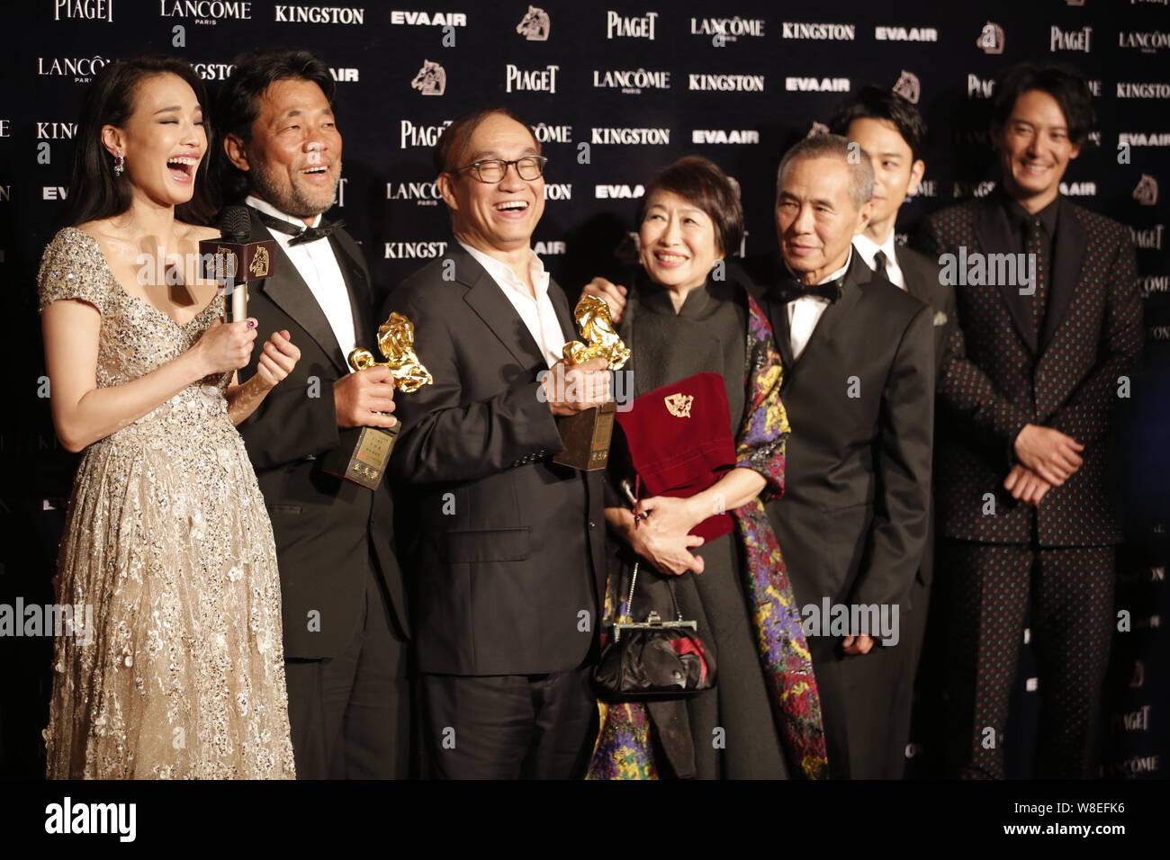 Taiwanese actress Shu Qi, left, cinematographer Mark Lee Ping Bing, second left, and director Hou Hsiao-hsien, second right, pose during the 52nd Gold Stock Photo
