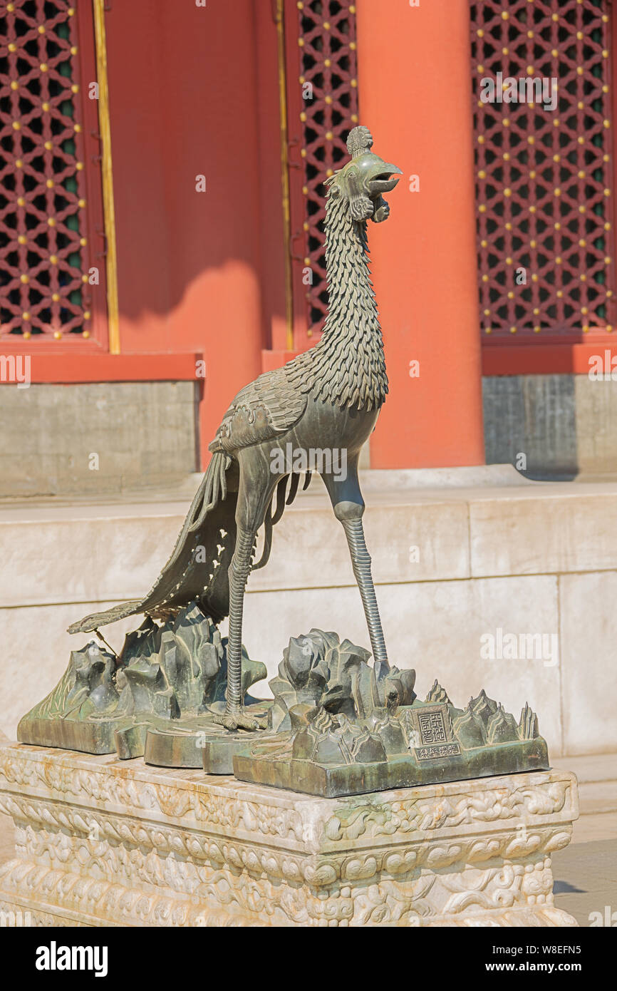 Standing in front of a phoenix at the Summer Palace, the former imperial garden Stock Photo