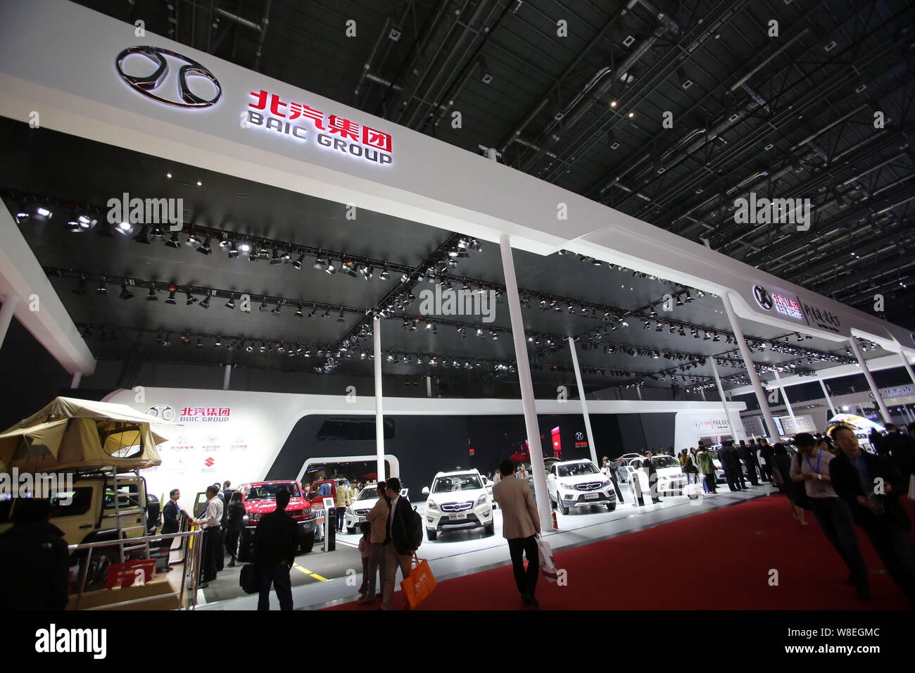 --FILE--Visitors walk past a stand of BAIC (Beijing Automobile International Corporation) during the 16th Shanghai International Automobile Industry E Stock Photo