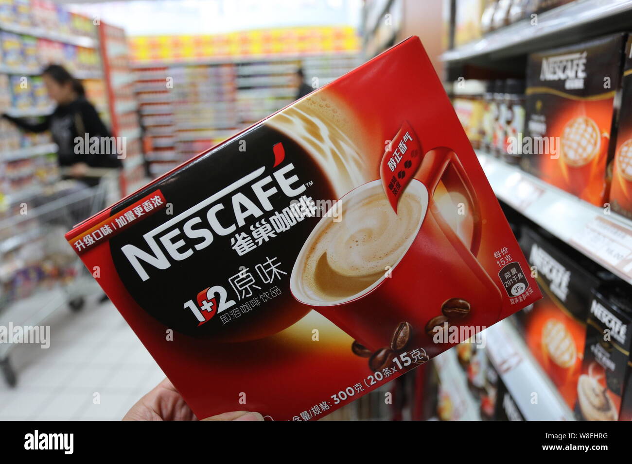 --FILE--A customer shops for a carton of Nescafe instant coffee of Nestle at a supermarket in Xuchang city, central China's Henan province, 7 December Stock Photo