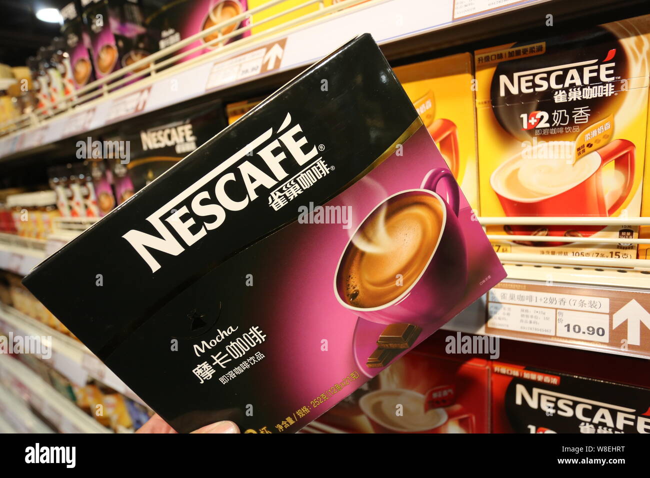 --FILE--A customer shops for a carton of Nescafe instant coffee of Nestle at a supermarket in Xuchang city, central China's Henan province, 16 October Stock Photo