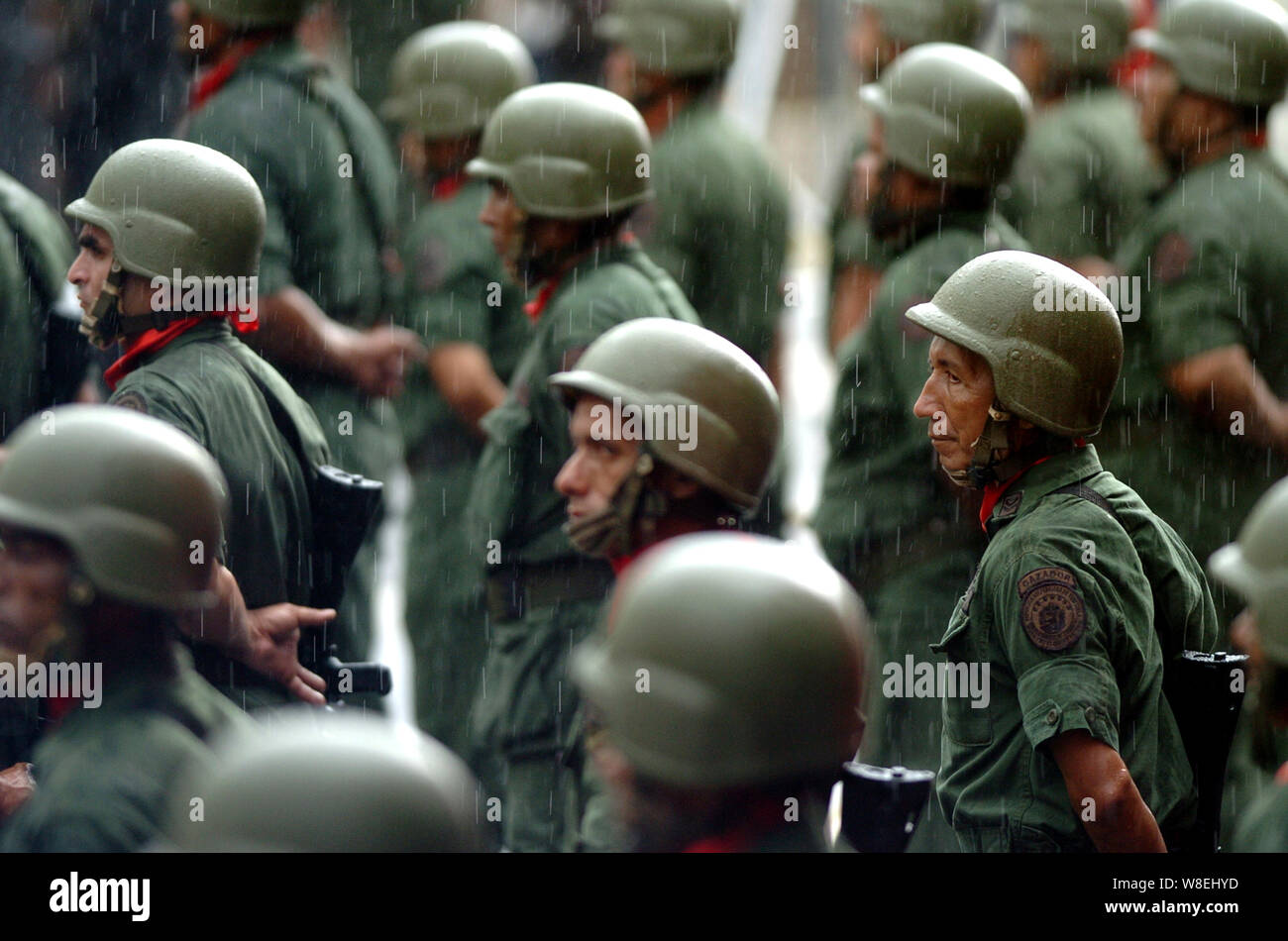 Venezuelan reservists stand under the rain during a parade with Venezuelan President Hugo Chavez in Caracas, Venezuela Stock Photo