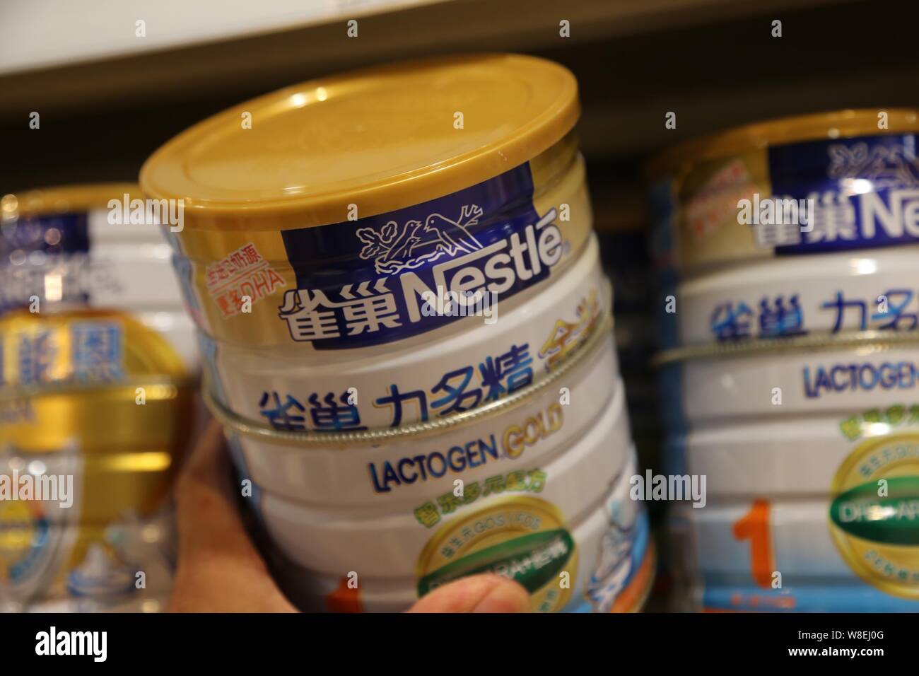 --FILE--A customer shops for a tin of Nestle infant formula at a supermarket in Xuchang city, central China's Henan province, 8 June 2014.   Nestle SA Stock Photo
