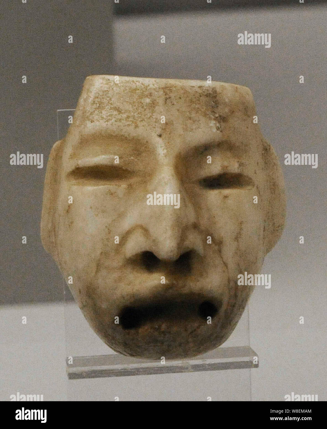 Mask with human features. White marble. Olmec culture. Middle Preclassic Period (1200-400 BC). Mexico, Gulf Coast. Museum of the Americas. Madrid, Spain. Stock Photo