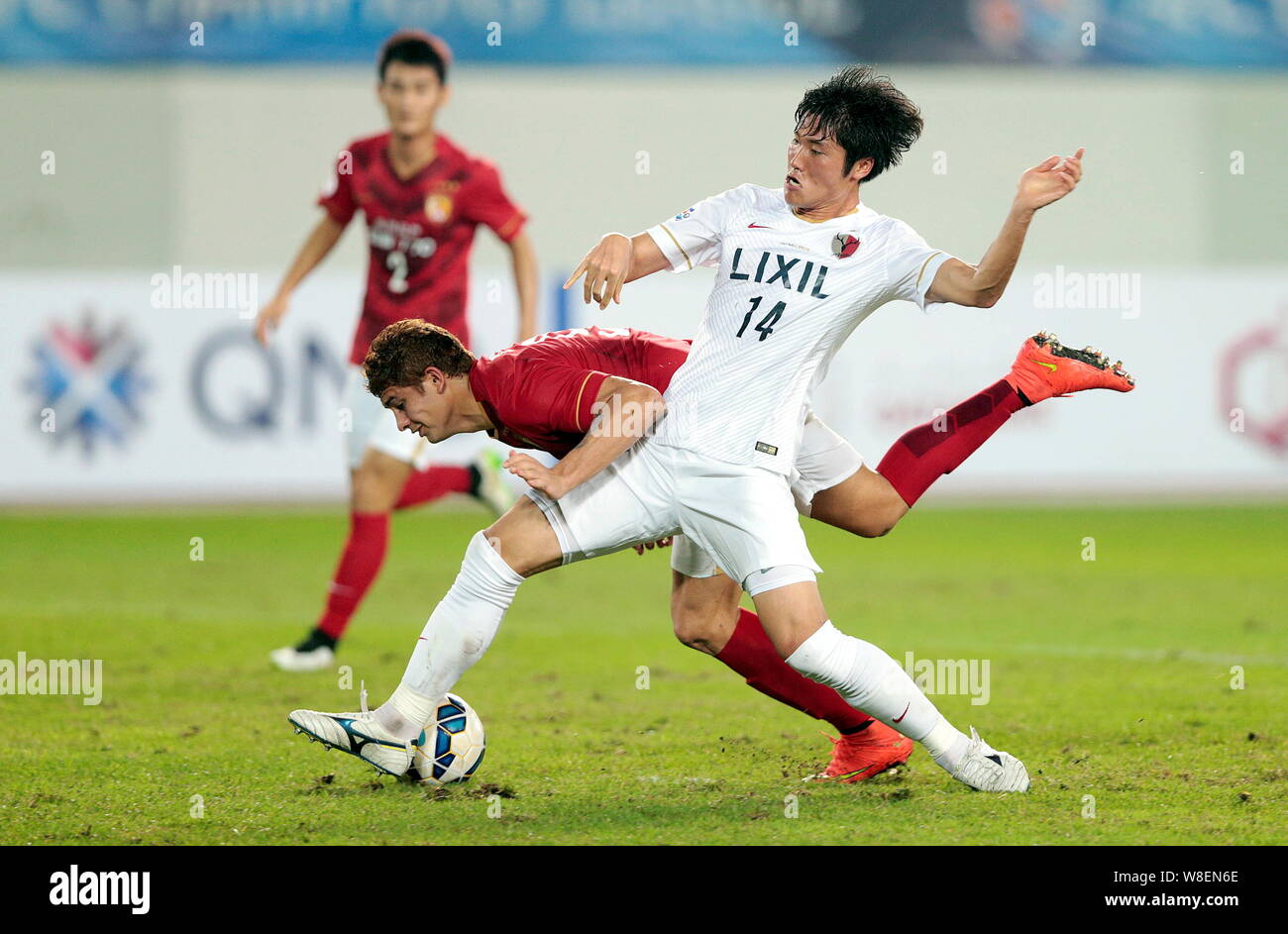 Elkeson of China's Guangzhou Evergrande, second front, challenges Hwang Seok-ho of Japan's Kashima Antlers during their 2015 AFC Champions League Grou Stock Photo