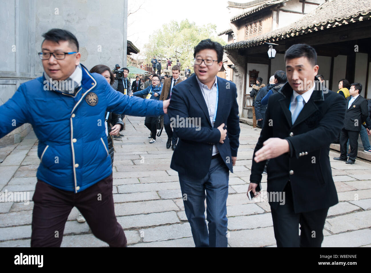 William Ding Lei, center, CEO of Netease (163.com), leaves after the opening ceremony for the 2nd World Internet Conference, also known as Wuzhen Summ Stock Photo