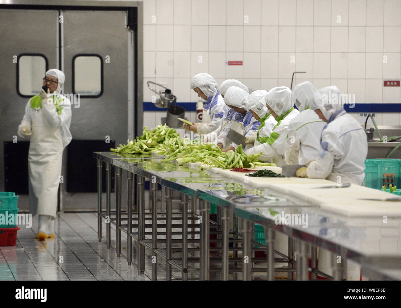 Chinese workers process vegetables at a food processing plant of ...