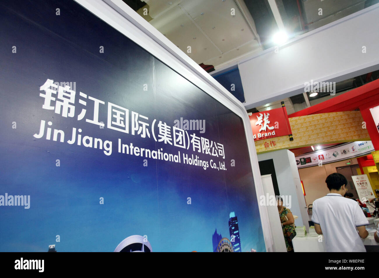 --FILE--A visitor is seen at the stand of Shanghai Jin Jiang International Holdings Co. Ltd. during a fair in Shanghai, China, 29 September 2014.   Sh Stock Photo