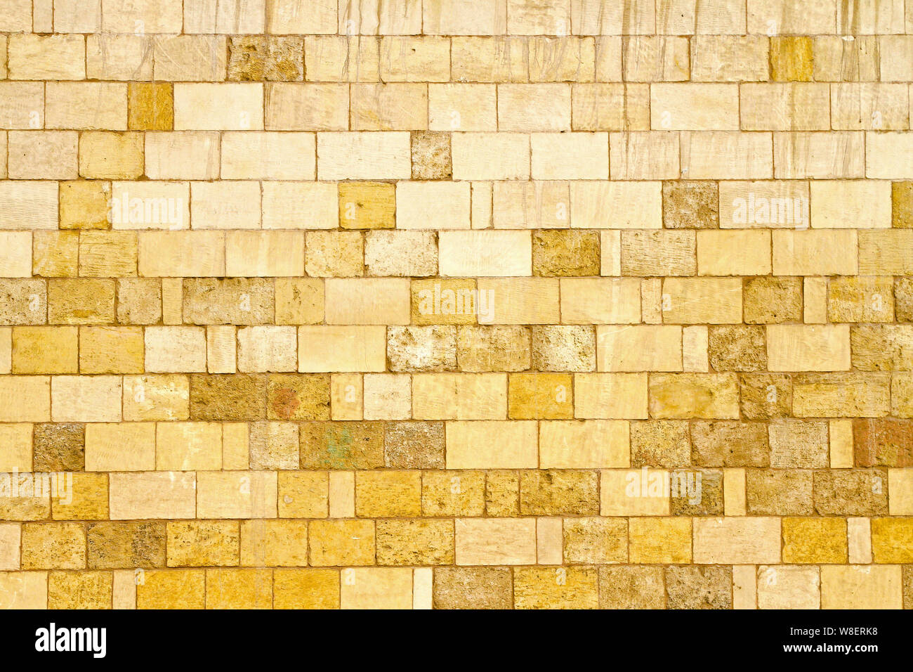 Big yellow wall made from stone bricks Stock Photo