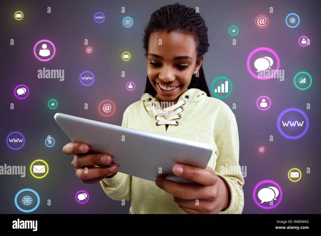 Communication technology. Young girl using tablet Stock Photo - Alamy