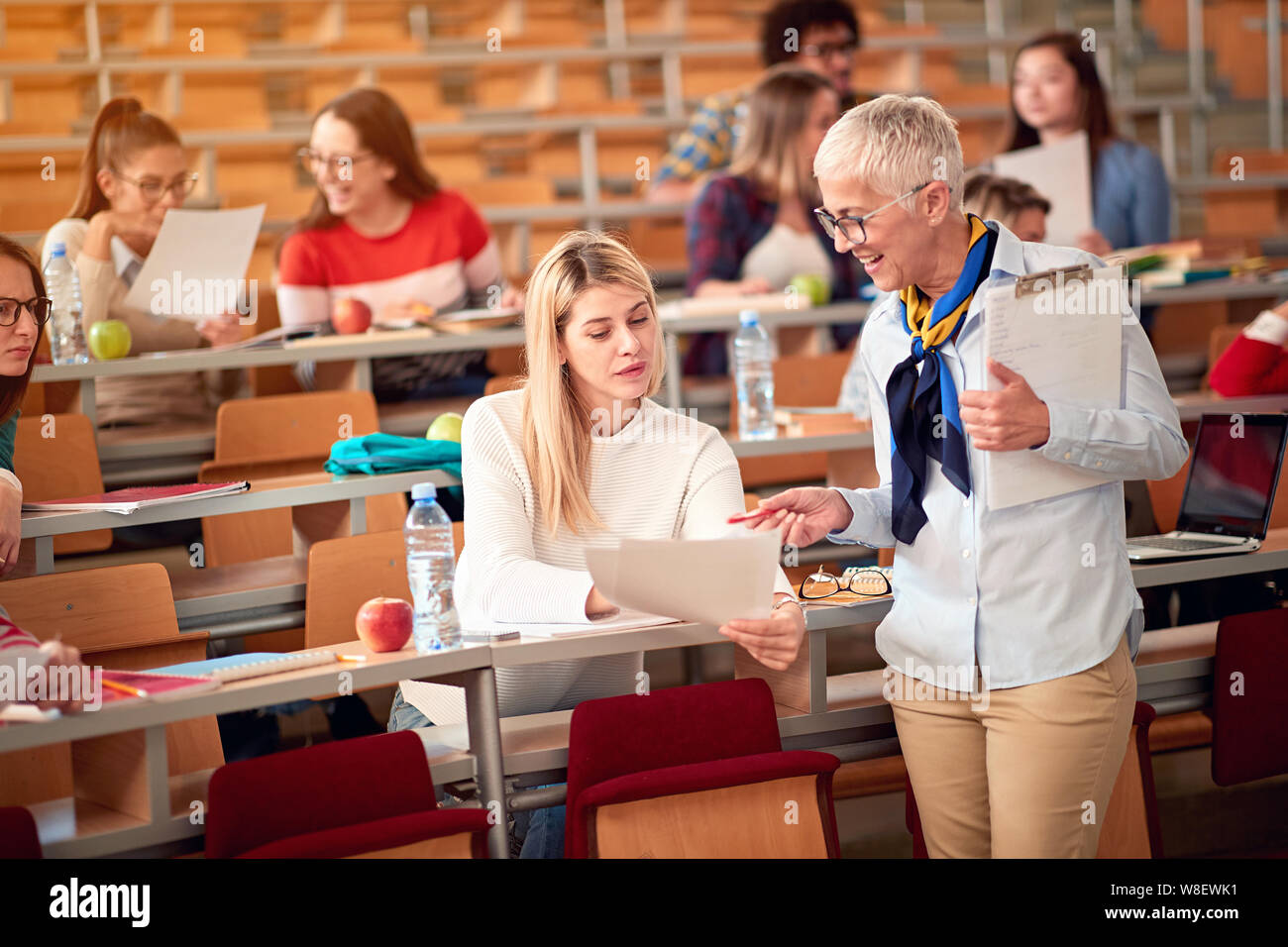 female lecturer with girl student in an exam in a classroom Stock Photo