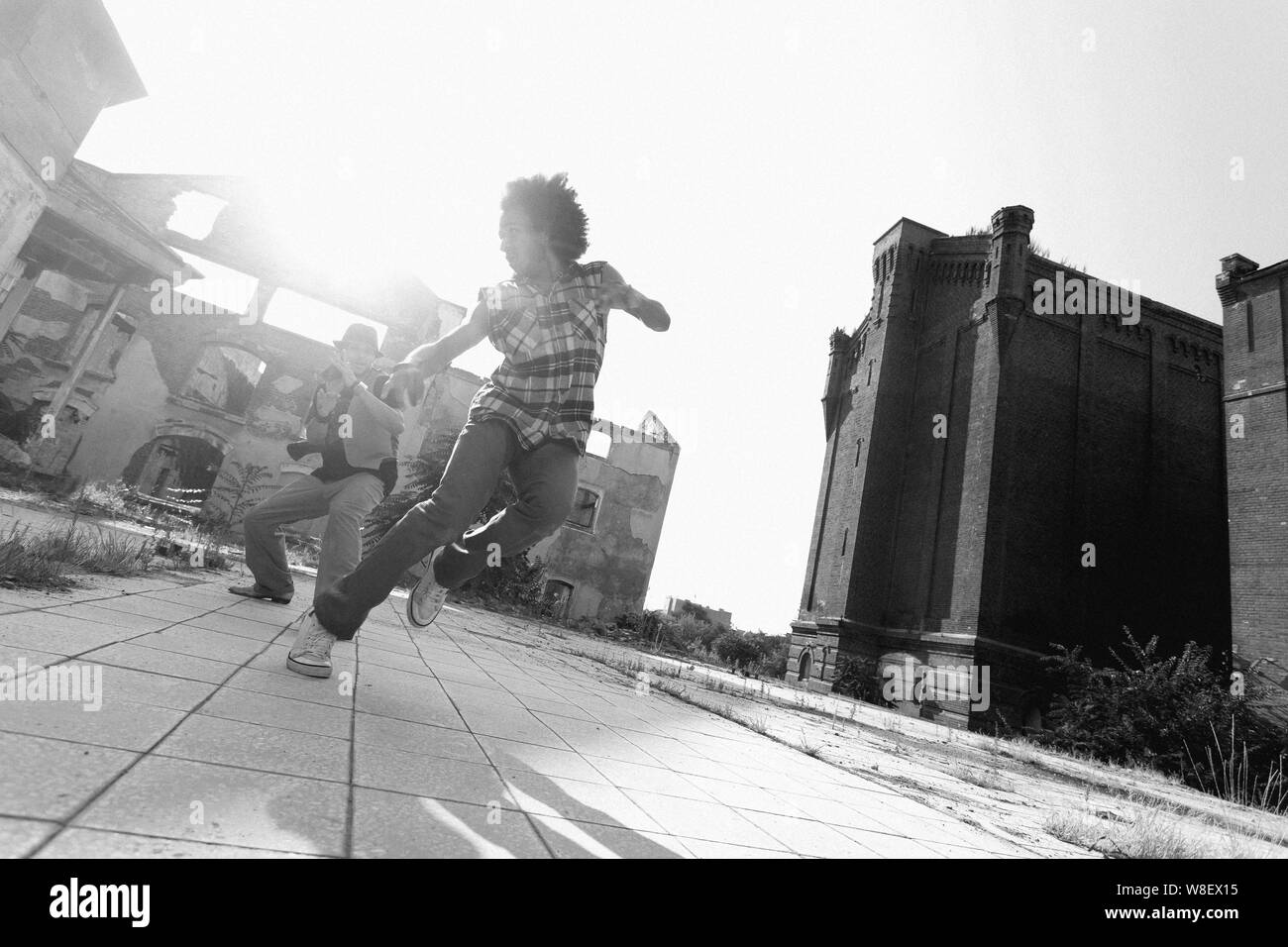Young African American man hip hop dancing in an urban square with a ...