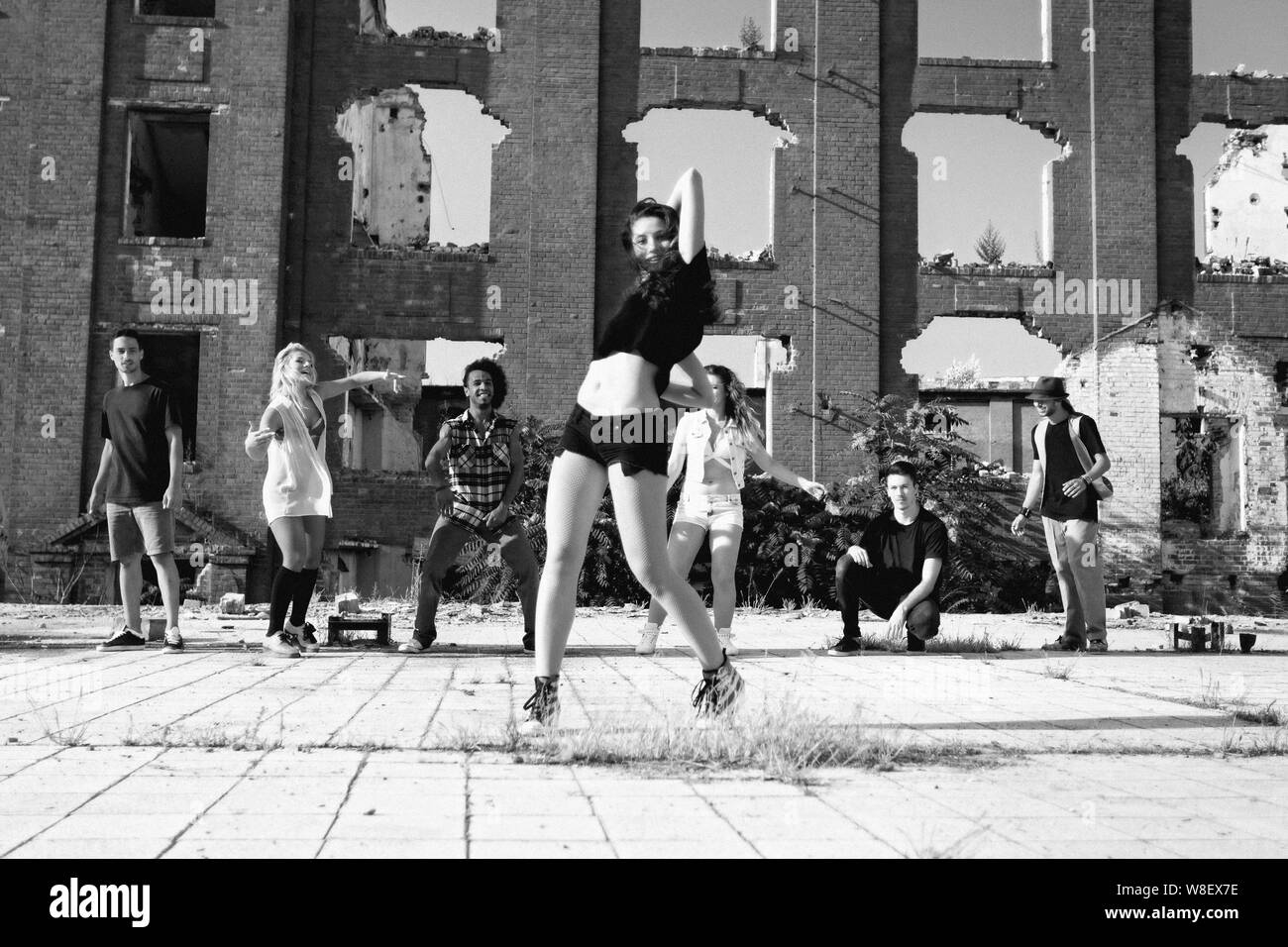 Young Girl hip hop dancing in an urban square with her friends ...