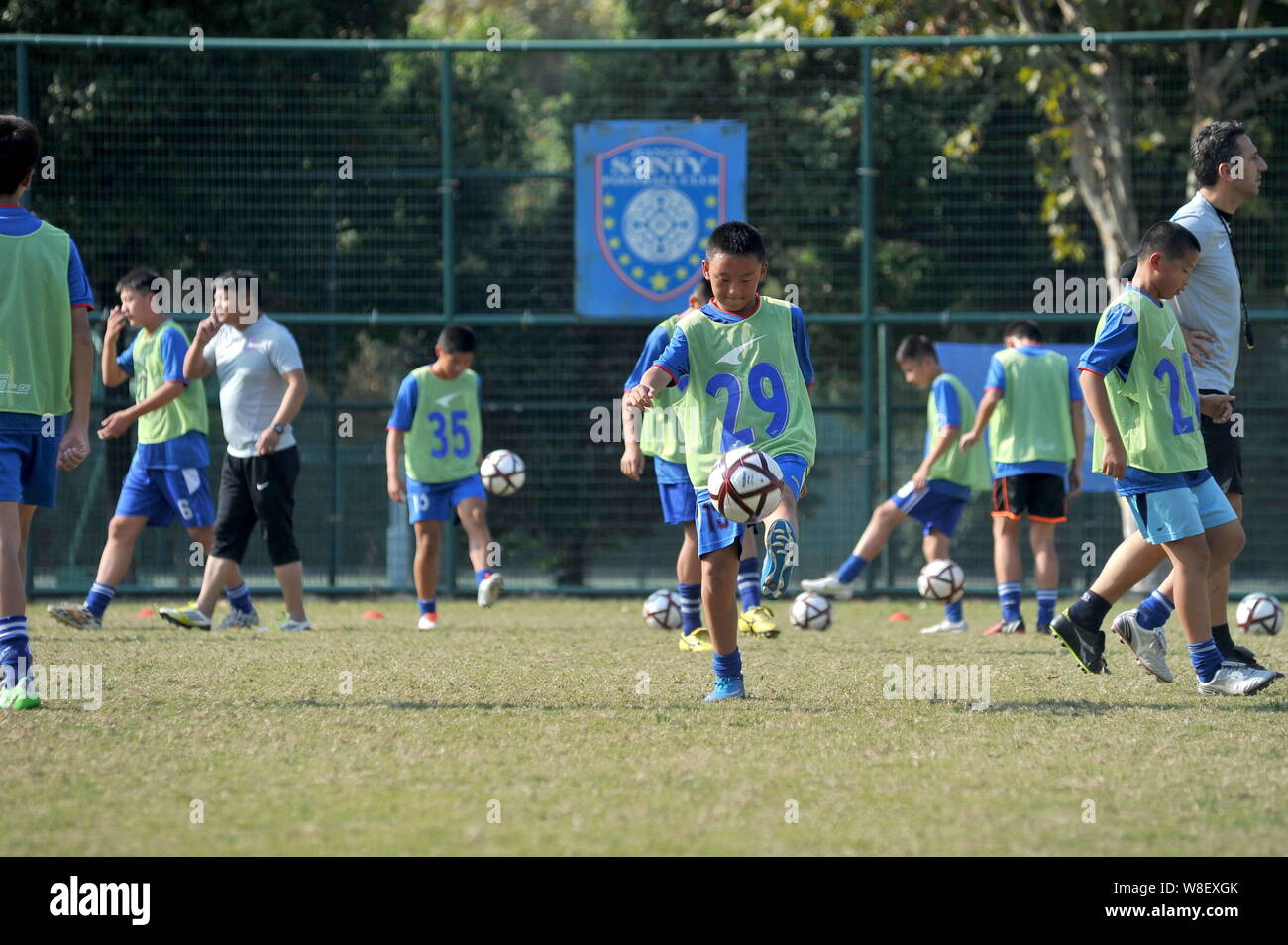 --FILE--Young Chinese boys practise during a training session at Jiangsu Guoxin Parma International Football School in Nanjing city, east China's Jian Stock Photo