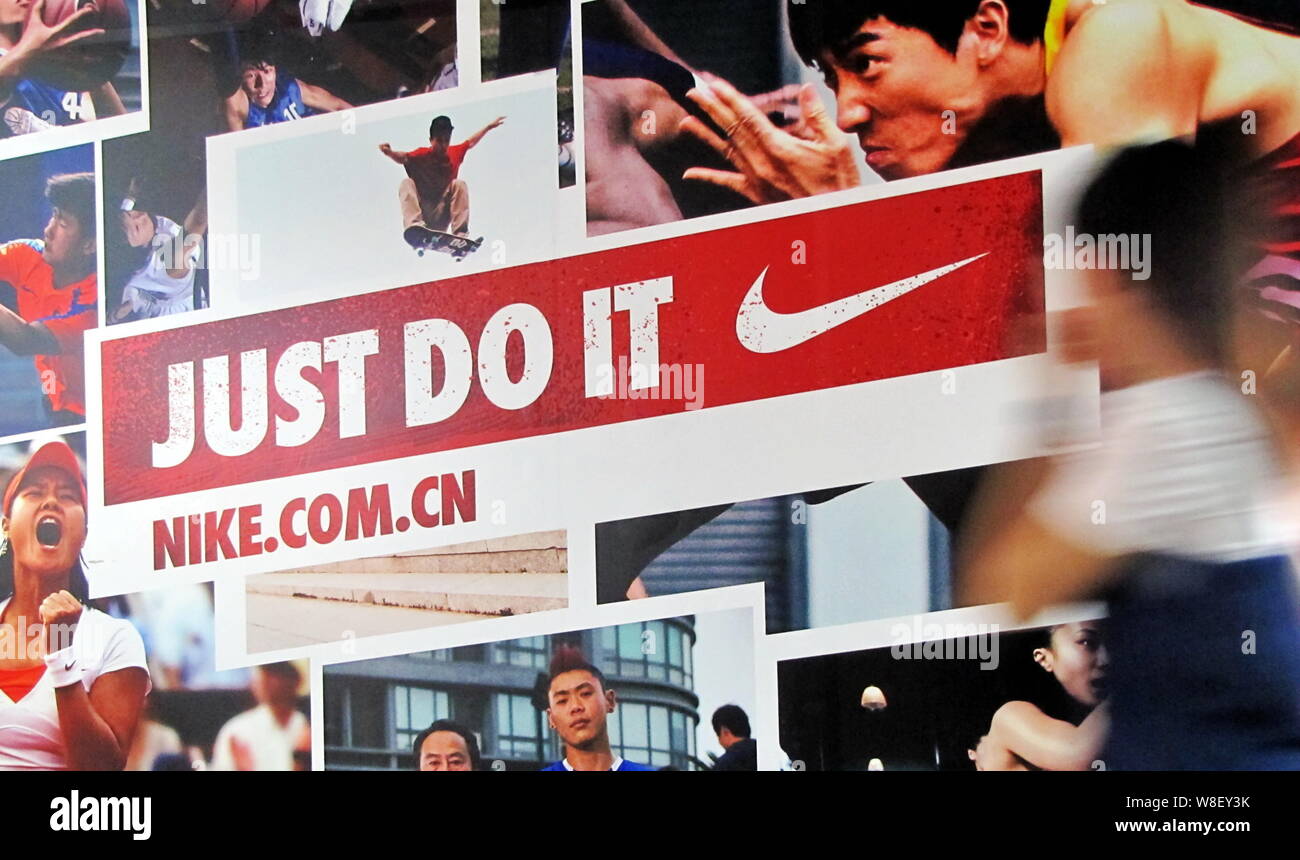 FILE--Pedestrians walk past an advertisement for Nike in Shanghai, China,  26 August 2011. Foreign direct investment (FDI) on the Chinese mainland  Stock Photo - Alamy