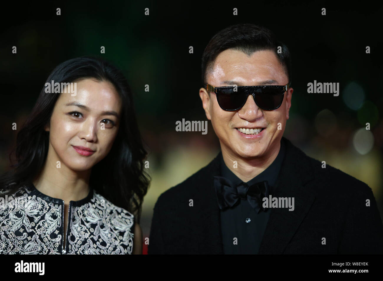 Chinese actress Tang Wei, left, and actor Sun Honglei pose on the red carpet for the 5th International Theatre Academy Award (Acting Award) in Beijing Stock Photo