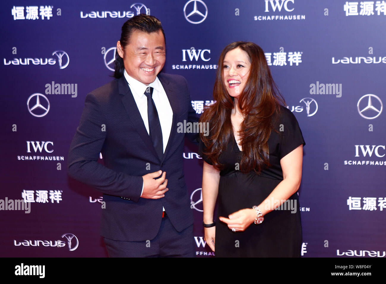 Pregnant Chinese tennis star Li Na, right, and her husband Jiang Shan pose on the red carpet for the 2015 Laureus World Sports Awards ceremony in Shan Stock Photo