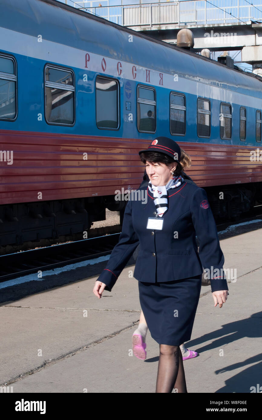 Chita Russia, Provodnista or carriage attendant on platform before train departure Stock Photo
